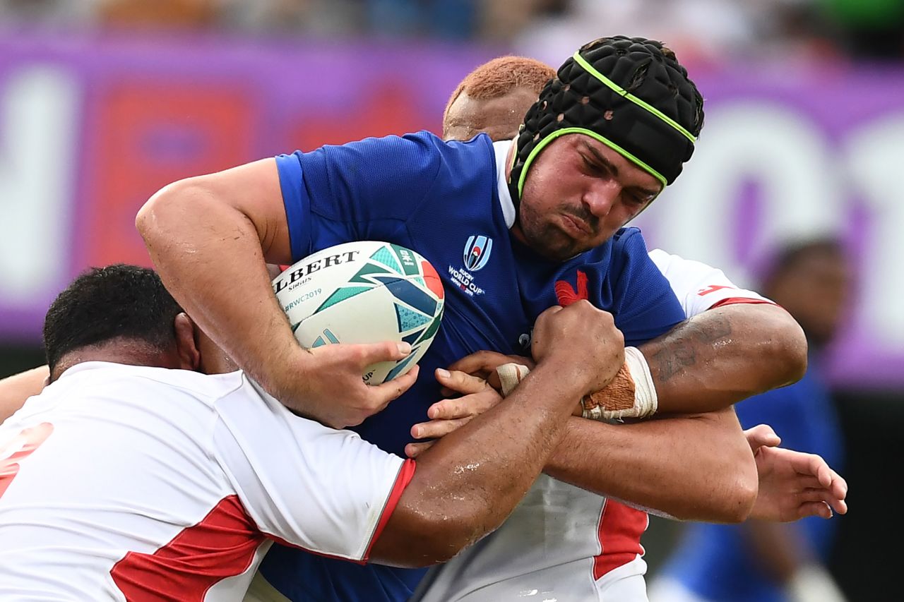 France's number 8 Gregory Alldritt, right, is tackled by Tonga's prop Ma'afu Fia. 