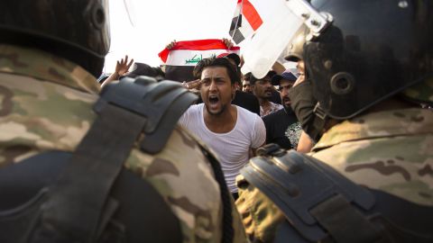 A protestor gestures in front of security forces during a demonstration on October 2.