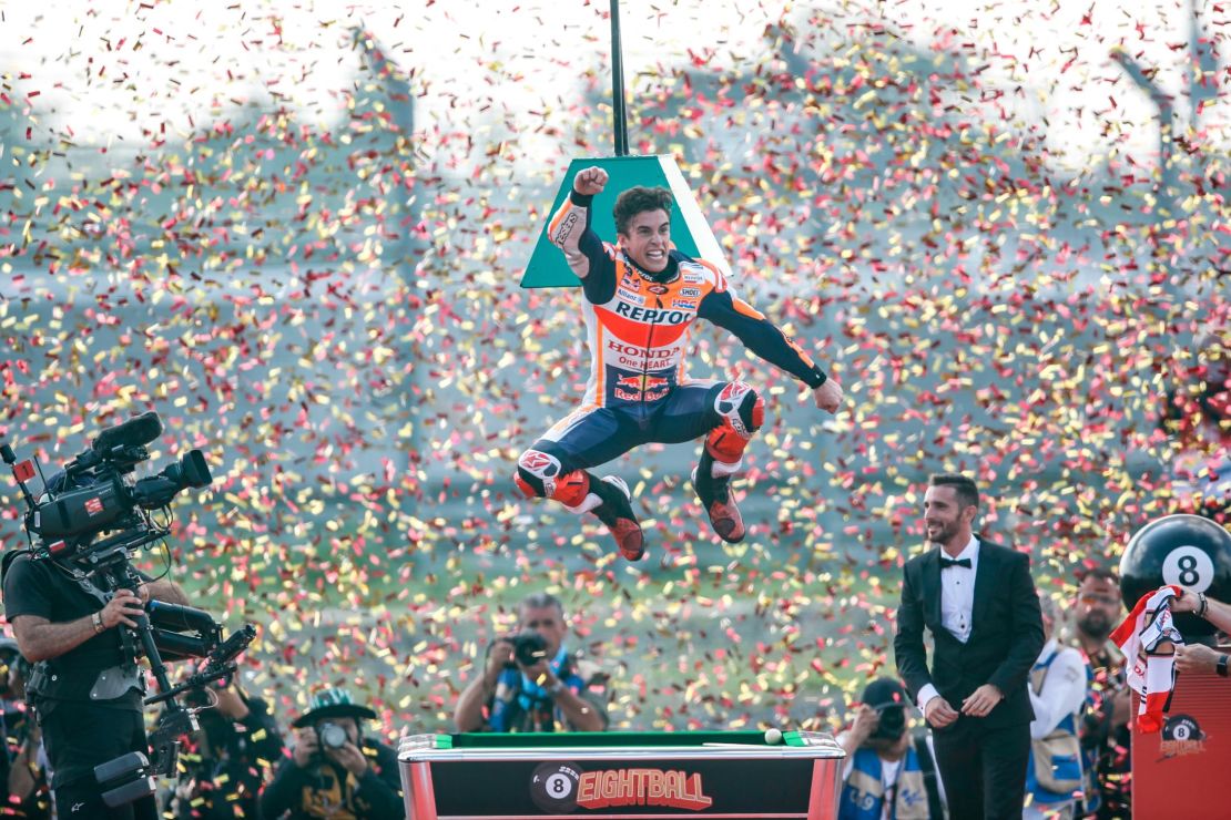 Marc Marquez jumps for joy as he celebrates his eighth world motorcycling title and sixth MotoGP crown.