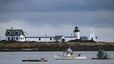 A lobster boat passes by the Goat Island Light at Cape Porpoise in Kennebunkport, Maine. 