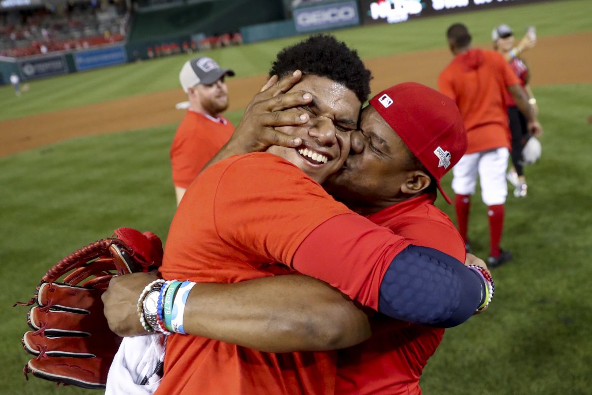 Juan Soto gets a kiss from his father after the Washington Nationals came from behind to defeat the Milwaukee Brewers in the National League wild-card game on Tuesday, October 1. Soto had the game-winning hit for the Nationals.