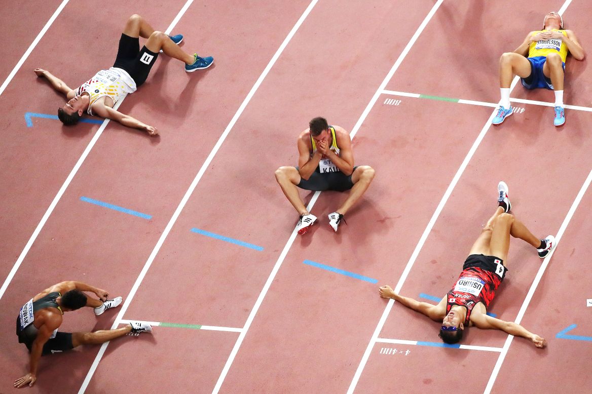 Exhausted decathletes rest after their 1,500-meter race at the World Championships on Thursday, October 3. At center is Germany's Niklas Kaul, who won gold.