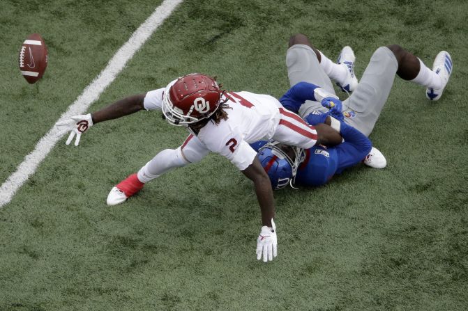 Kansas' Azur Kamara tackles Oklahoma wide receiver CeeDee Lamb during a college football game in Lawrence, Kansas, on Saturday, October 5.