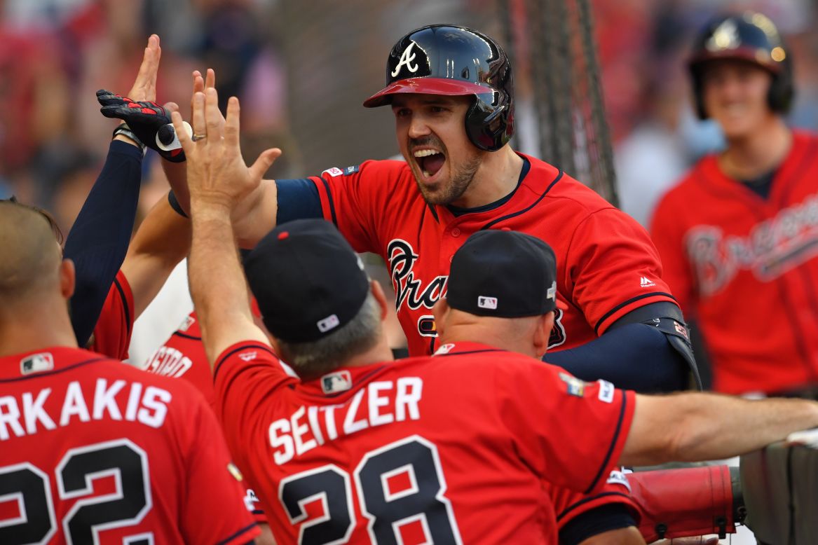 Atlanta's Adam Duvall celebrates with teammates after hitting a pinch-hit home run in the playoff game against St. Louis on Friday, October 4. Duvall also hit a go-ahead single on Sunday to help give the Braves a 2-1 series lead.