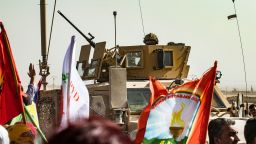 A soldier sits atop an armoured vehicle during a demonstration by Syrian Kurds against Turkish threats at a US-led international coalition base on the outskirts of Ras al-Ain town in Syria's Hasakeh province near the Turkish border on October 6, 2019. - Ankara had reiterated on October 5 an oft-repeated threat to launch an "air and ground" operation in Syria against a Kurdish militia it deems a terrorist group. (Photo by Delil SOULEIMAN / AFP) (Photo by DELIL SOULEIMAN/AFP via Getty Images)