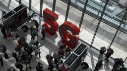 Visitors walk past 5G branding during the launch of Vodafone Group Plc's 5G wireless network in London, U.K., on Wednesday, July 3, 2019. Vodafone switched on the U.K.'s second 5G wireless network on Wednesday, kicking off a commercial battle with dominant rival EE that could shape a decade of sales. Photographer: Simon Dawson/Bloomberg via Getty Images