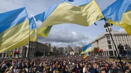 Demonstrators wave Ukraine national flags as they gather in central Kiev on October 6, 2019 to protest broader autonomy for separatist territories, part of a plan to end a war with Russian-backed fighters. Protesters chanted "No to surrender!", with some holding placards critical of President Volodymyr Zelensky in the crowd, which police said had swelled to around 10,000 people. Ukrainian, Russian and separatist negotiators agreed on a roadmap that envisages special status for separatist territories if they conduct free and fair elections under the Ukrainian constitution.