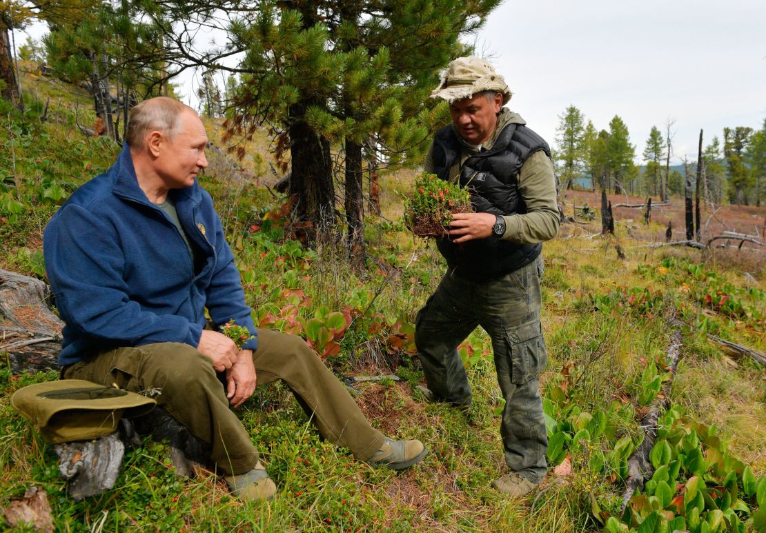 In this undated photo released by Russian Presidential Press Service, Russian President Vladimir Putin, left, talks with Russian Defense Minister Sergei Shoigu in Siberia during a break from state affairs ahead of his birthday. Russian president chose the Siberian taiga forest to go on a hike ahead of his birthday on Oct. 7.