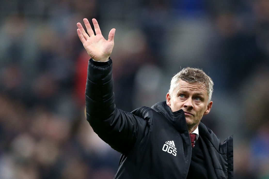 Manchester United coach Ole Gunnar Solskjaer waves to the fans at full-time at Newcastle.