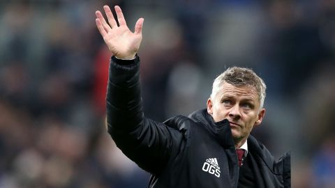 Manchester United coach Ole Gunnar Solskjaer waves to the fans at full-time at Newcastle.