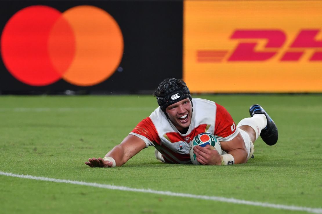 Japan's flanker Pieter Labuschagne dives and scores a try against Russia.