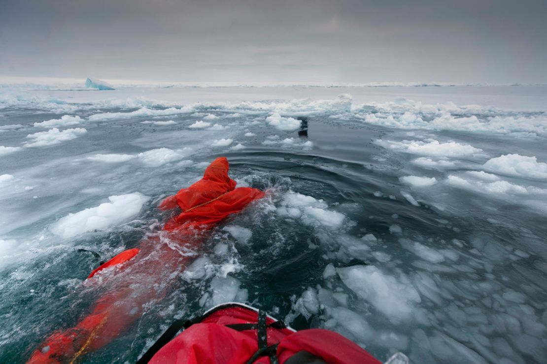 British polar explorer Anne Daniels swimming between ice floes on her way to the Geographic North Pole in 2010. Reaching the North Pole is becoming harder on foot, says Hartley (the last successful expedition from land was in 2014). 