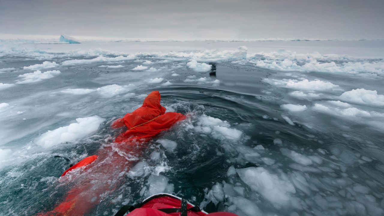 British polar explorer Anne Daniels swimming between ice floes on her way to the Geographic North Pole in 2010. Reaching the North Pole is becoming harder on foot, says Hartley (the last successful expedition from land was in 2014). 