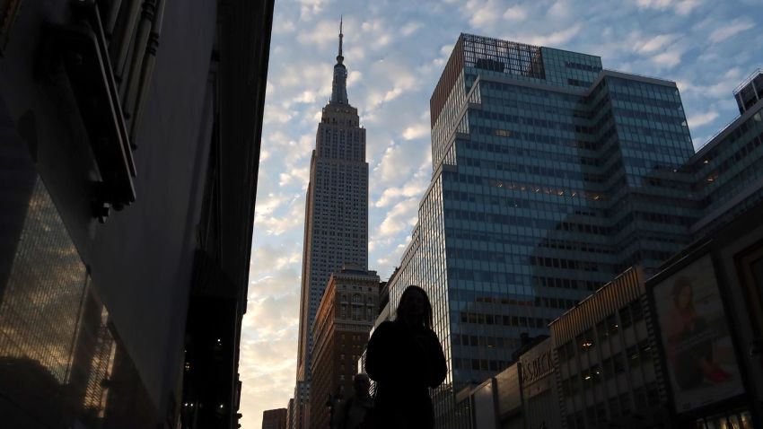 NEW YORK, NY - SEPTEMBER 28: The sun rises behind the Empire State Building as a person walks along 34th Street on September 28, 2019, in New York City. (Photo by Gary Hershorn/Getty Images)