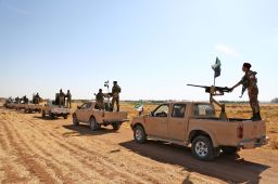 Turkish-backed Syrian rebel fighters head to an area near the Syrian-Turkish border north of Aleppo on October 8, 2019. 