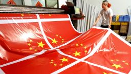 A worker produces inkjet printing national flags at a factory in Lianyungang in China's eastern Jiangsu province on September 17, 2019, ahead of the 70th anniversary of the founding of the People's Republic of China. (Photo by STR / AFP) / China OUT        (Photo credit should read STR/AFP/Getty Images)