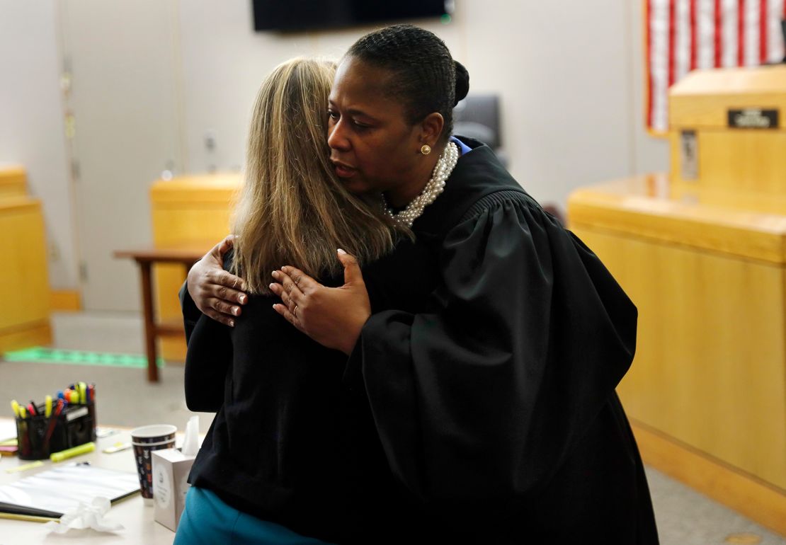 Judge Tammy Kemp hugs former Dallas police officer and convicted murderer Amber Guyger before Guyger leaves for jail.