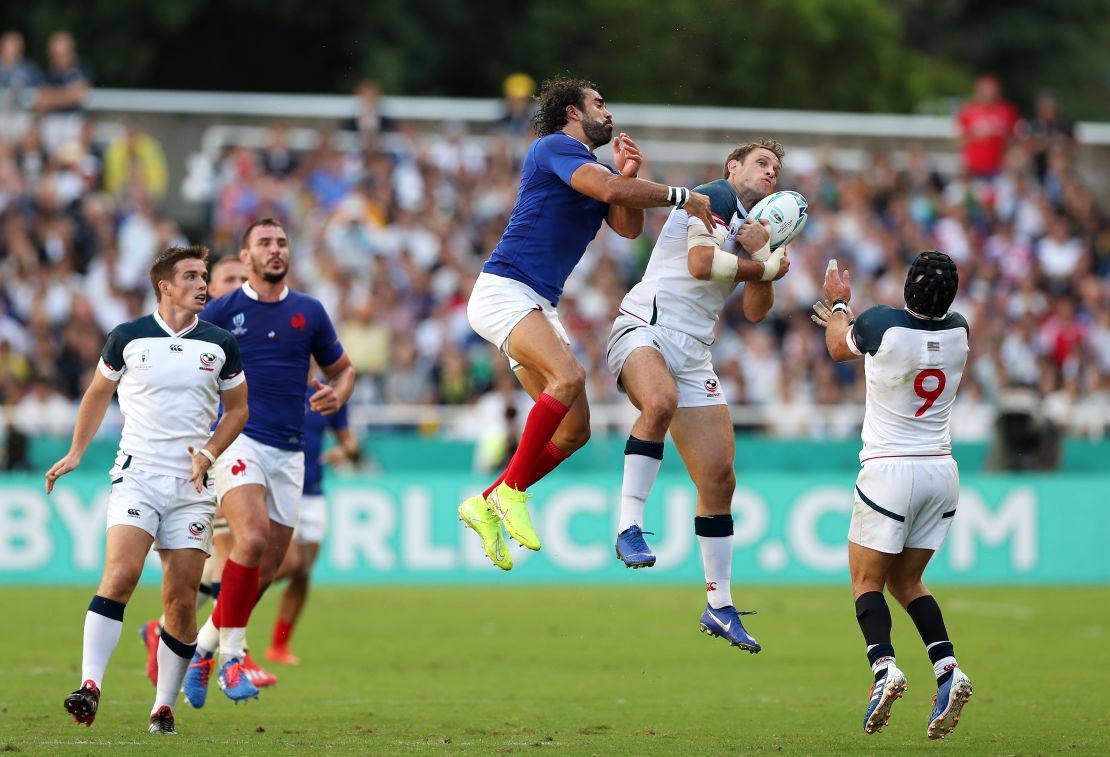 Blaine Scully (center) competes for a high ball against France. 