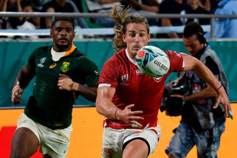Canada's Jeff Hassler runs for the ball during the Pool B match against South Africa but his side were on the wrong end of a 66-7 drubbing. 