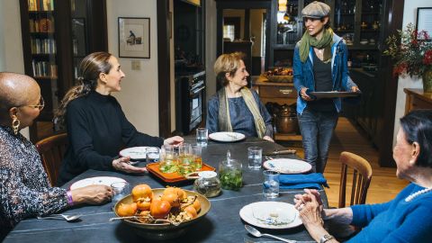 Family Meal San Francisco roundtable shot of Alice Waters, Cecilia Chiang, Tanya Holland, and Gabriela Cámara while Dominique Crenn serves her dessert