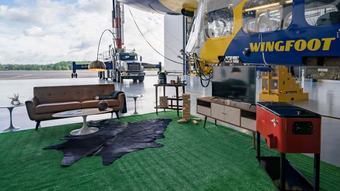 For guests who need to stretch their legs, Goodyear set up a living room-style space just outside the blimp with a TV and open bar.