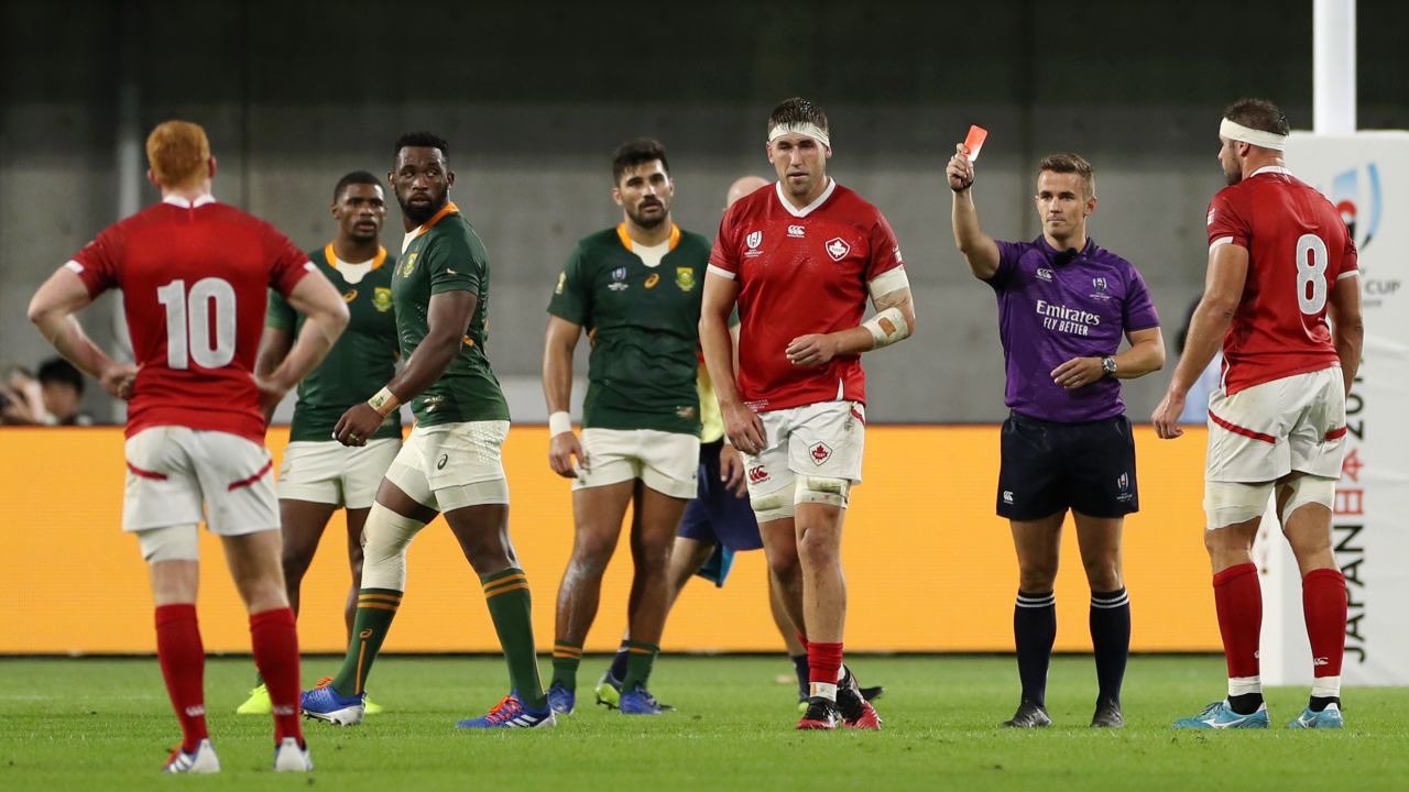 Josh Larsen is shown a red card by referee Luke Pearce.