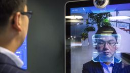 Xu Li, chief executive officer of SenseTime Group Ltd., is identified by the company's facial recognition system on a screen as he poses for a photograph at SenseTime's showroom in Beijing, China, on Friday, June 15, 2018. 