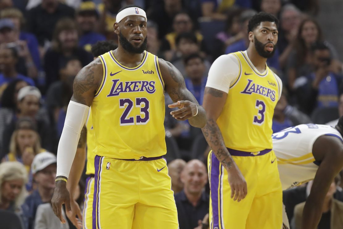Los Angeles Lakers forward LeBron James (23) in front of forward Anthony Davis (3) during the first half of a preseason NBA basketball game against the Golden State Warriors in San Francisco.