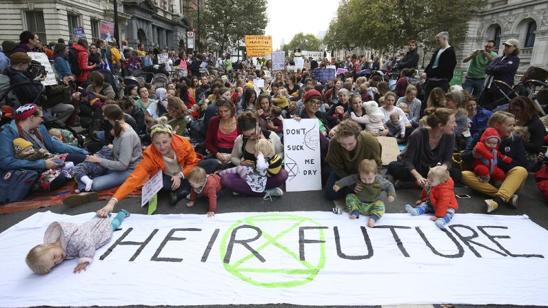 Mothers gather ahead of the Extinction Rebellion "nurse-in" road blockade in London on Wednesday, October 9.