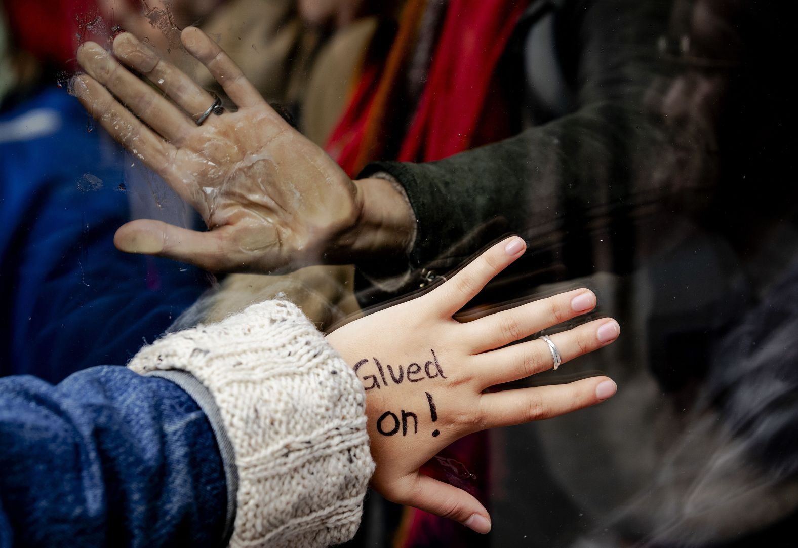 Climate activists glue themselves to the entrance of a power company's offices in Amsterdam, Netherlands, on October 8.