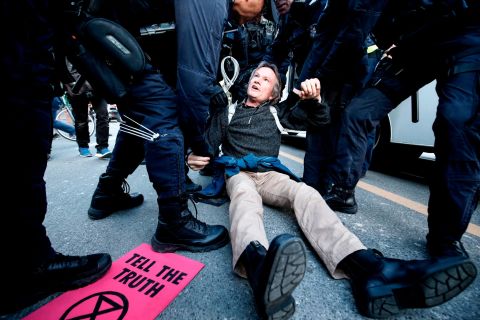 A man is detained in Melbourne as he takes part in an Extinction Rebellion protest on Monday, October 7. More than 50 people were arrested throughout Australia that day.