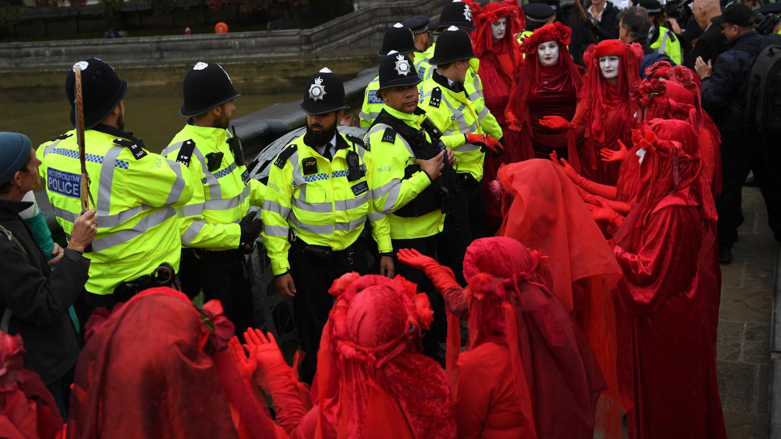 The Red Brigade surrounds police in London on October 7. This crimson-robed troupe is common at Extinction Rebellion protests and is the creation of the Invisible Circus, a street performance group.