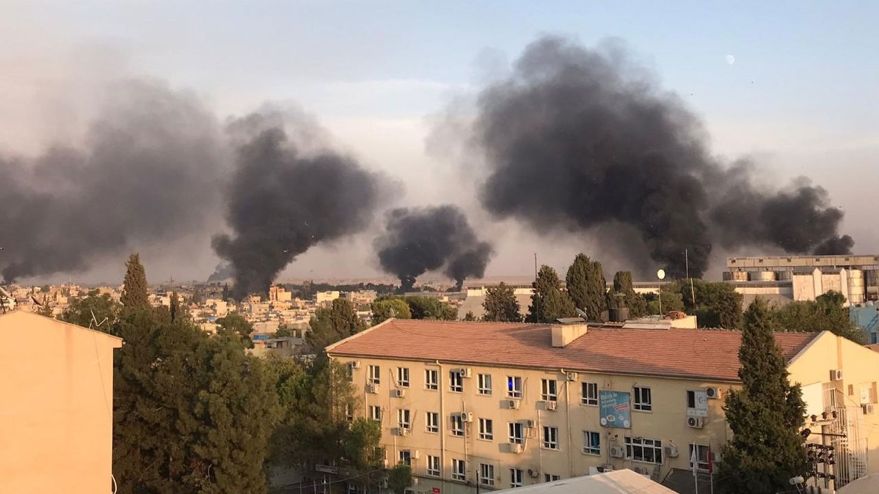 A photo taken from Turkey's Sanliurfa province shows smoke rising at the site of Ras al-Ain.