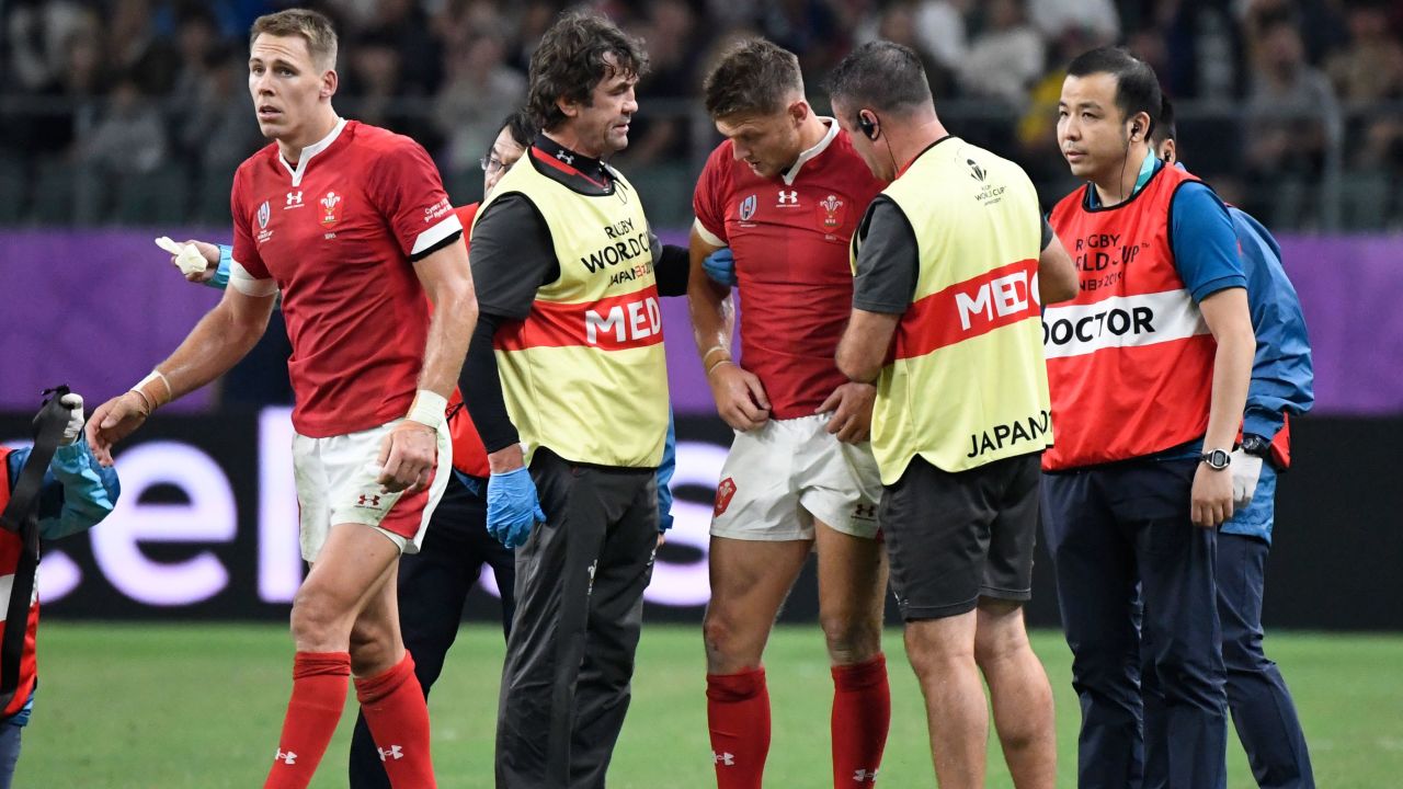 Dan Biggar is attended to by medics after a collision with Liam Williams.