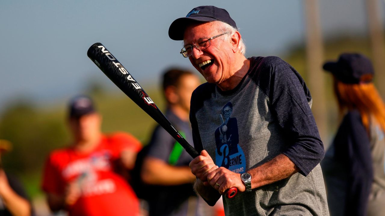 Democratic presidential candidate Sen. Bernie Sanders shares a laugh as he warms up before a softball game on August 19 in Dyersville, Iowa. 