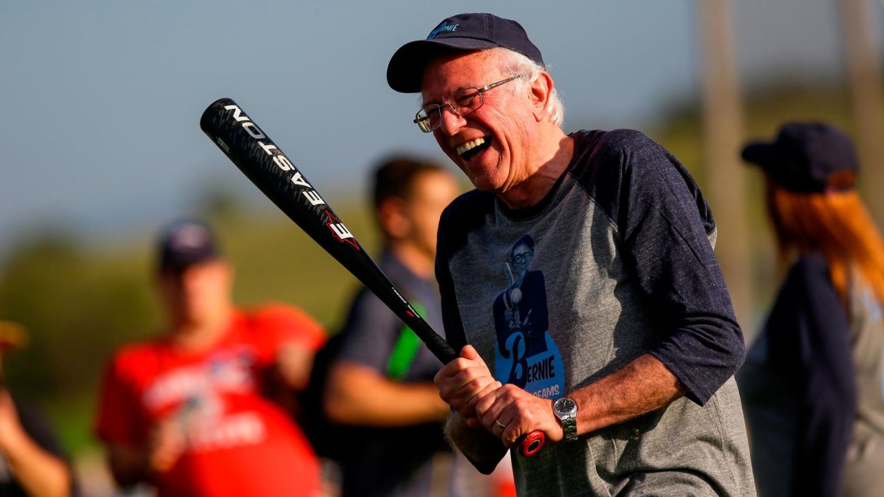 Democratic presidential candidate Sen. Bernie Sanders shares a laugh as he warms up before a softball game on August 19 in Dyersville, Iowa.
