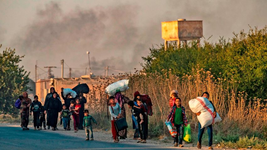 TOPSHOT - Civilians flee with their belongings amid Turkish bombardment on Syria's northeastern town of Ras al-Ain in the Hasakeh province along the Turkish border on October 9, 2019. - Turkey launched a broad assault on Kurdish-controlled areas in northeastern Syria today, with intensive bombardment paving the way for an invasion made possible by the withdrawal of US troops. (Photo by Delil SOULEIMAN / AFP) (Photo by DELIL SOULEIMAN/AFP via Getty Images)