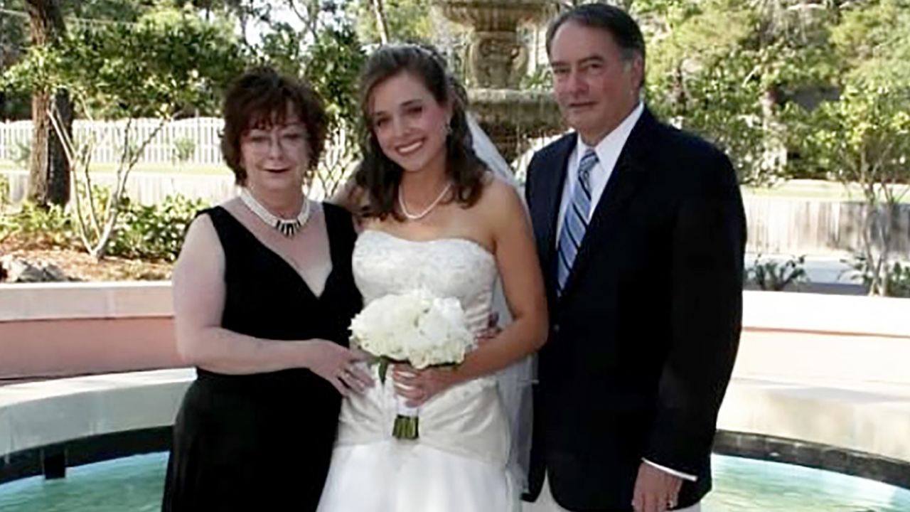 Melisa Raney poses with her parents.