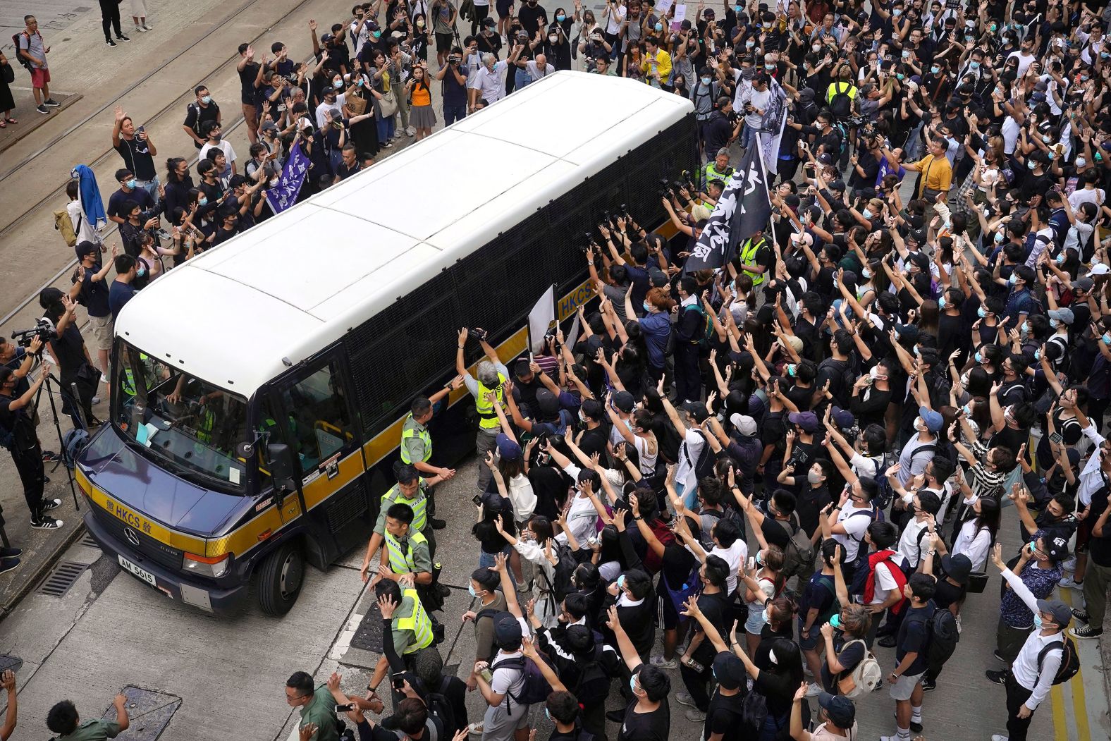 Supporters surround a police bus carrying political activist Edward Leung as it leaves the High Court in Hong Kong on Wednesday, October 9. Several hundred masked protesters gathered at Hong Kong's High Court for the appeal hearing of Leung, <a href="https://www.cnn.com/2018/06/11/asia/edward-leung-hong-kong-jailed-intl/index.html" target="_blank">who was sentenced to six years in prison</a> for his part in a violent clash with police.