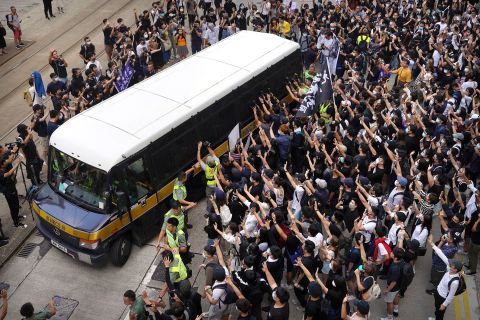 Supporters surround a police bus carrying political activist Edward Leung as it leaves the High Court in Hong Kong on Wednesday, October 9. Several hundred masked protesters gathered at Hong Kong's High Court for the appeal hearing of Leung, <a href="https://www.cnn.com/2018/06/11/asia/edward-leung-hong-kong-jailed-intl/index.html" target="_blank">who was sentenced to six years in prison</a> for his part in a violent clash with police.