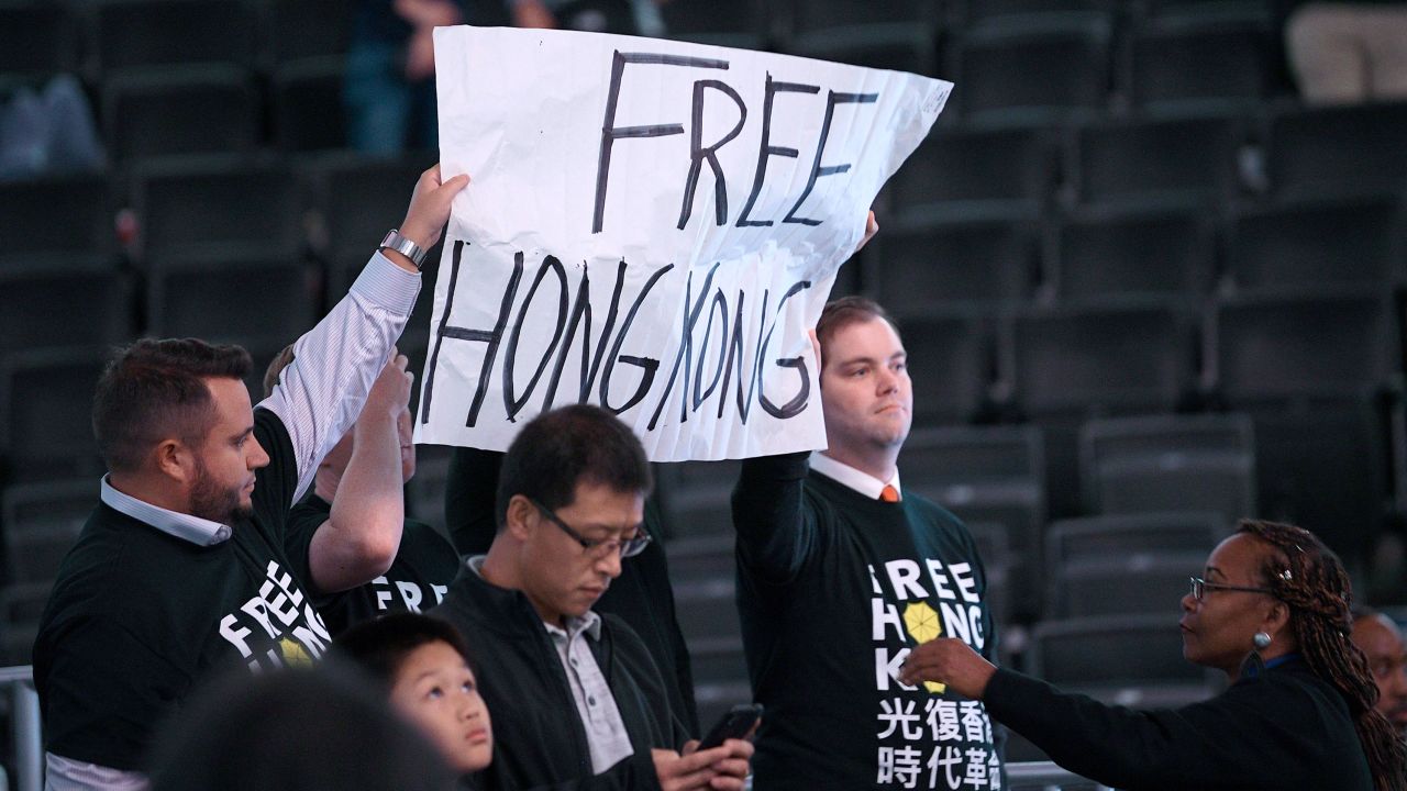 Activists hold up a sign before an NBA exhibition basketball game between the Washington Wizards and the Guangzhou Loong-Lions, Wednesday in Washington.