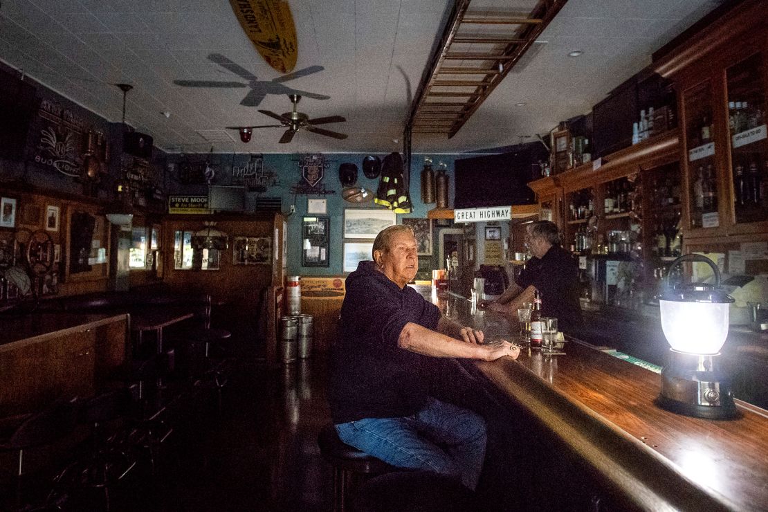 Joseph Pokorski drinks a beer at a bar on Wednesday in Sonoma, California, as the city faces a power outage.