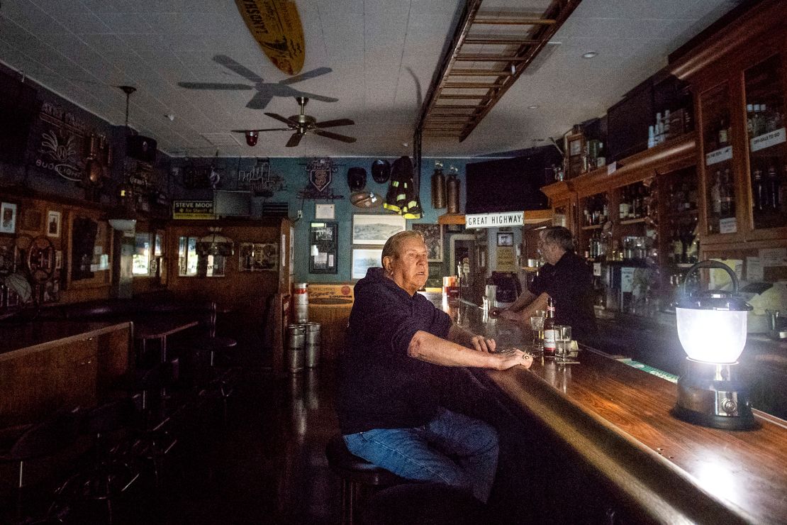 Joseph Pokorski drinks a beer at the Town Square as downtown Sonoma, California, remains without power on Wednesday.