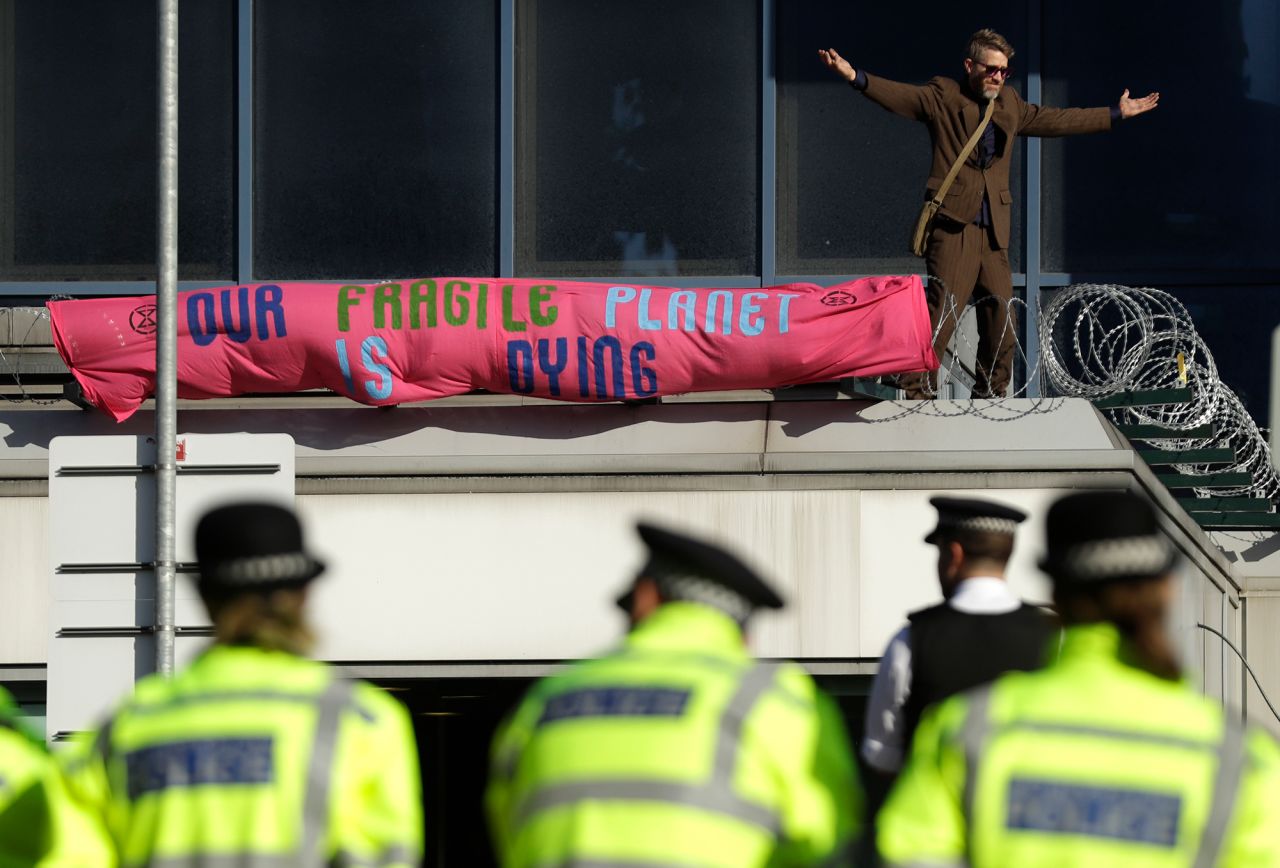A demonstrator displays a banner at the City Airport in London.
