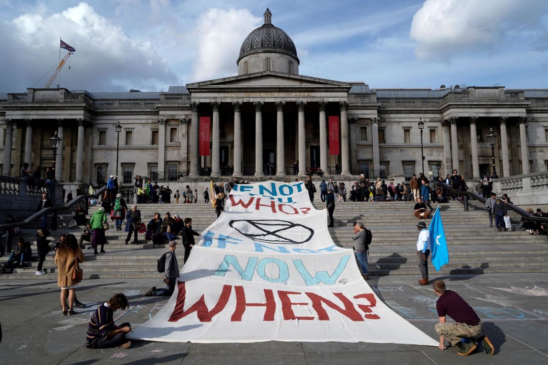 Climate activists protest on the steps of the National Gallery in Trafalgar Square.