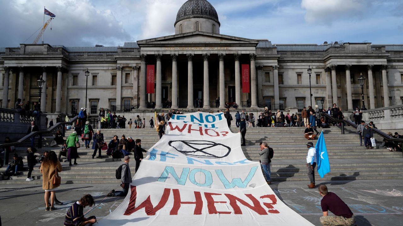 Climate activists protest on the steps of the National Gallery in Trafalgar Square.