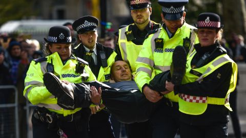 Police arrest an activist during Extinction Rebellion demonstrations on Whitehall on October 9.