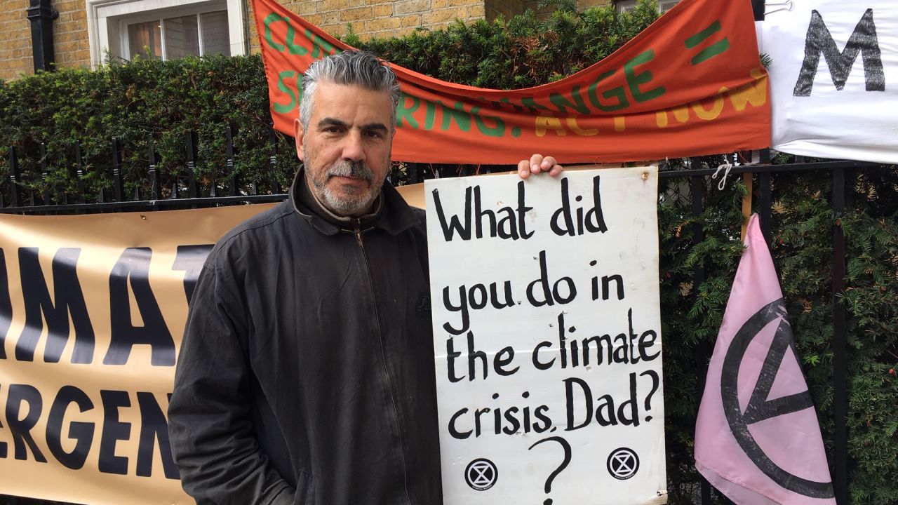 Andrew David Peel stands on a street near St James's Park holding a placard which, he says, sums up why he has become involved with the movement.