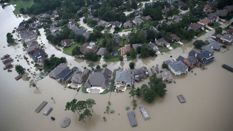 Flooded homes are shown near Lake Houston following Hurricane Harvey on August 30, 2017, in Houston. A new report finds that current flood insurance coverage rates greatly underestimate the actual financial risk flooding poses to millions of homeowners. 