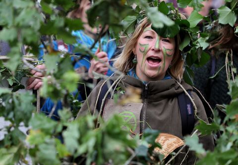Extinction Rebellion protesters march as a "human forest" in Dublin. They were heading to Leinster House to call for a complete remodeling of forestry policy.